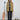 Person wearing a yellow plaid shirt with a microphone and roller skates in the background