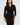 Woman wearing a black wrap dress against a white background