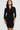 Woman wearing a black wrap dress against a white background