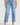 Person wearing light blue jeans on a white background