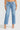 Person wearing light blue jeans on a white background
